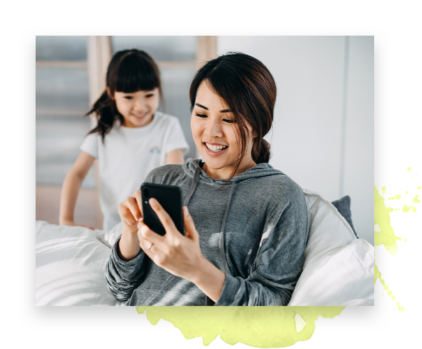 woman looking at phone with child