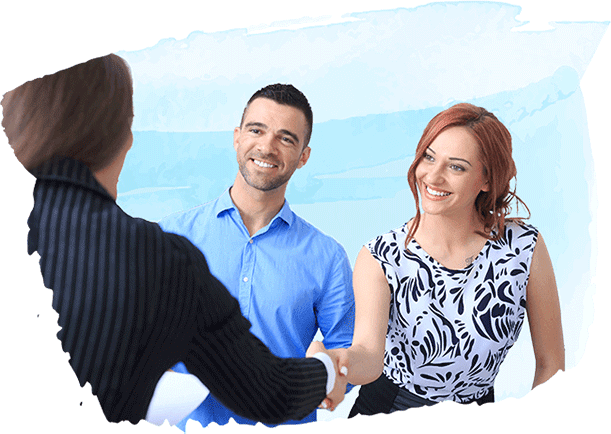 couple shaking hands with business person